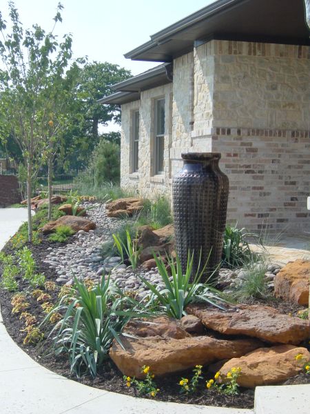 boulder and rock landscaping with disappearing fountain
